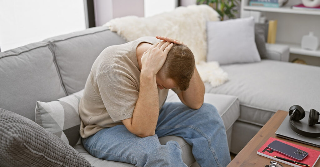 Man stressed on couch